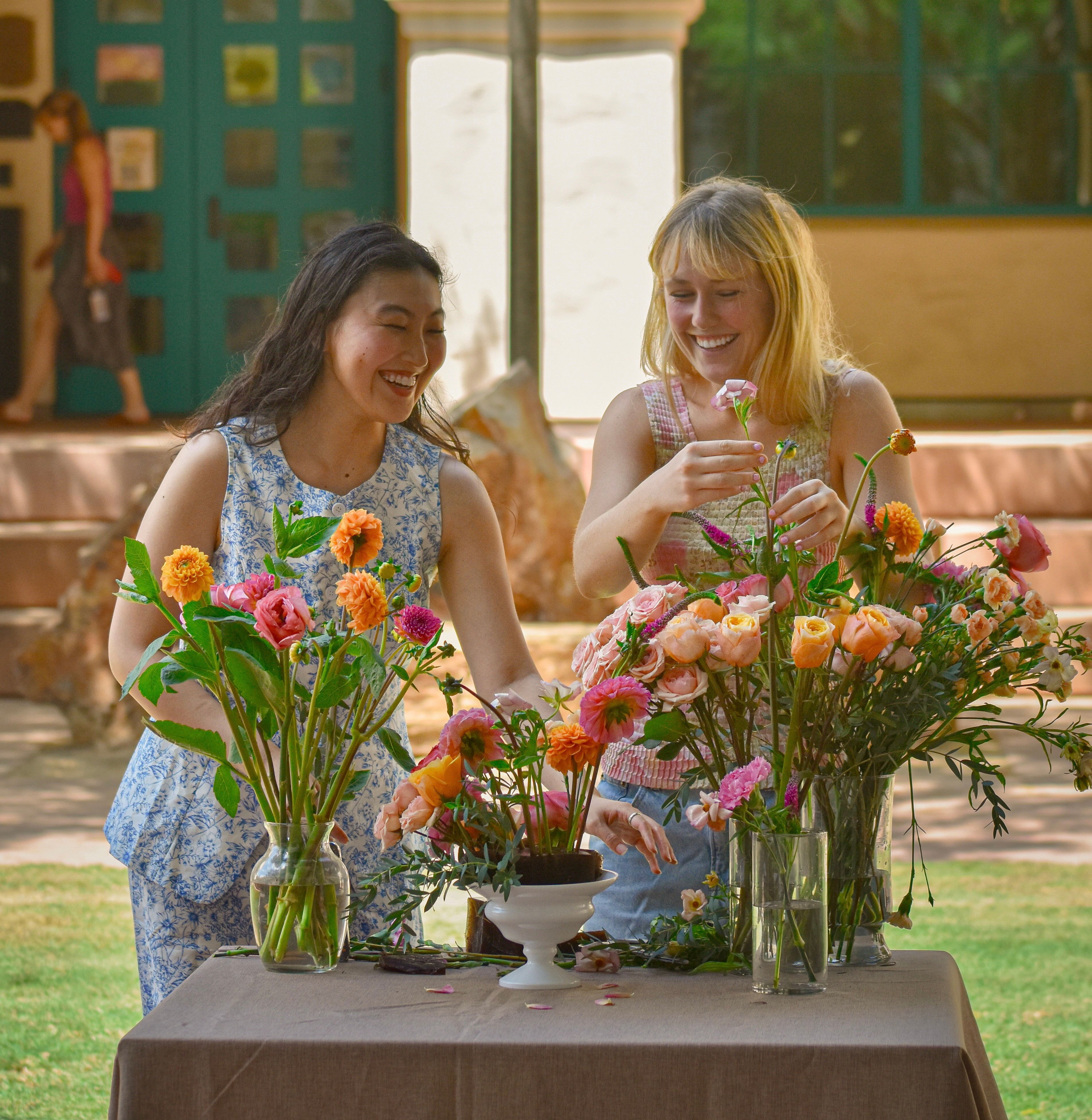 Kanna and Rachel creating a floral arrangement